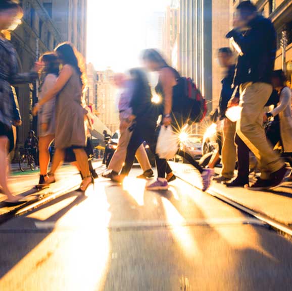 People walking across road in cityscape
